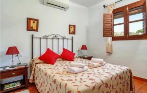 a bedroom with a bed with red pillows on it at Casa La Era in Frigiliana +21 photos