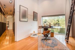 a living room with a chair and a table at Encinas4 - Villa de lujo by A-Cero Living in Pozuelo de Alarcón +15 photos