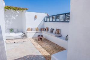 a white patio with two couches and a table at Riad Orb Private Riad Breakfast Included in Marrakech