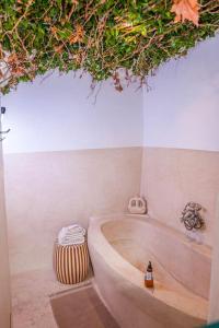a bathroom with a bath tub with plants above it at Riad Orb Private Riad Breakfast Included in Marrakech +38 photos