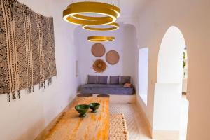 a living room with a table and a couch at Riad Orb Private Riad Breakfast Included in Marrakech