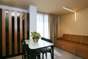 a living room with a table and a couch at Residence Terminus in Rimini