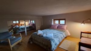 a bedroom with a large bed and a chair in it at Alina's House in Arachova +43 photos