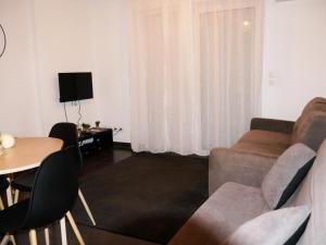 un soggiorno con un divano e un tavolo di Capstay studio avec grande terrasse proche aéroport Bastia - Lucciana - Centre a Lucciana