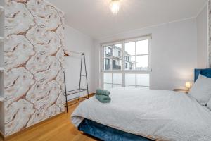 a bedroom with a bed and a window at Pétrusse Élite Suites - Elegant Suites Luxembourg City Center in Luxembourg