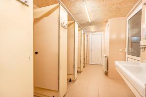 a corridor of a bathroom with a sink and a mirror at Rectoria de Claverol in Claverol