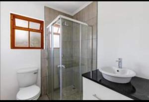 a bathroom with a toilet and a sink at De Rust Karoo Cottages in De Rust