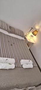 a bed with towels on it in a room at De Rust Karoo Cottages in De Rust