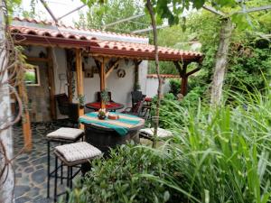 a patio with a table and chairs in front of a house at Villa Popovi in Simitli