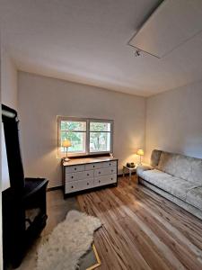 a living room with a couch and a window at Górska Otulina in Wilkowisko