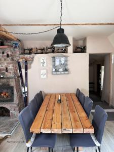 a dining room with a wooden table and chairs at Marchewkowe Pole in Sośnina +55 photos