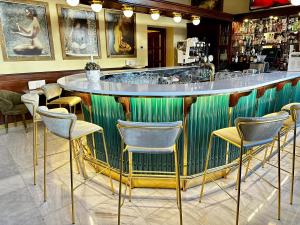 a green bar with chairs and a counter in a restaurant at Green Garden Hotel in Prague
