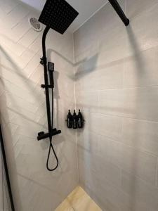 a shower with a black shower head in a bathroom at Zen Mayar House Toulouse centre in Toulouse +20 photos