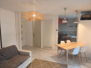 a dining room and living room with a table and chairs at Bagneres de luchon Hyper Centre in Luchon