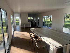 a dining room with a large wooden table and chairs at La Soñada in Lobos