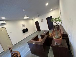 a room with a potted plant on a table at Villa Wistaria- Luxury 7BHK Villa With Private Pool in Alibaug