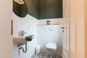 a bathroom with a sink and a toilet at Backhaus 3 in Staberdorf +38 photos
