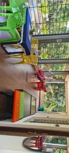 a room with a bunch of colorful items hanging from the ceiling at Saanvi Farmhouse in Hampi