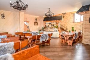 a dining room with wooden tables and chairs at Marysieńka Pokoje Hrube Wyżne 12A in Zakopane