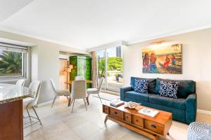 a living room with a couch and a table at Luana Waikiki Hotel & Suites in Honolulu