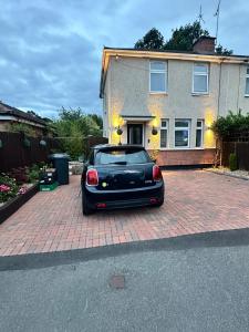 a black car parked in front of a house at Room to Rent in Worcester