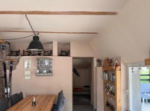 a dining room with a wooden table and chairs at Marchewkowe Pole in Sośnina +52 photos