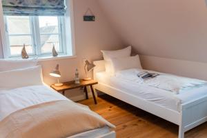 a bedroom with two beds and a window at Lokelk Lunhüs Hausteil 4 in Oevenum