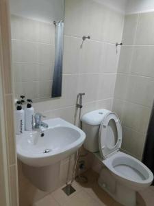 a bathroom with a white toilet and a sink at Cozy Condo near US EmbassyErmita Manila/ Roxas blvd/ Dolomite beach in Manila