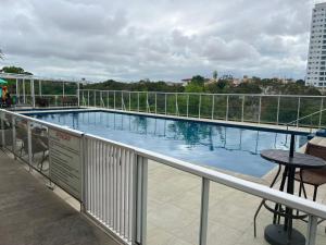 a swimming pool on the balcony of a building at Apto mobiliado e aconchegante - 3 quartos e 4 camas - Lazer completo e localização privilegiada in João Pessoa
