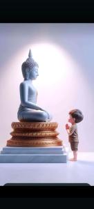 a little boy standing next to a statue of aitatingitating woman at Saanvi Farmhouse in Hampi