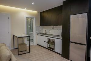 a kitchen with a refrigerator and a counter top at Vollgaapartment2 in Durrës