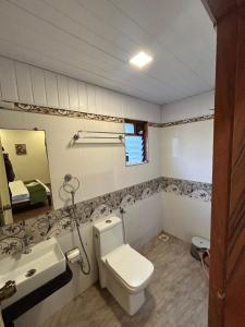 a bathroom with a toilet and a sink at Villa Wistaria- Luxury 7BHK Villa With Private Pool in Alibaug +30 photos