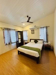 a bedroom with a bed and a ceiling fan at Villa Wistaria- Luxury 7BHK Villa With Private Pool in Alibaug
