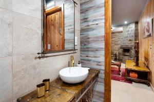 a bathroom with a white sink on a wooden counter at Cantinho do Sossego in Várzea +20 photos