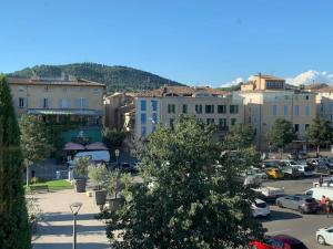 a city with cars parked in a parking lot at Duplex T3 climatisé centre terrasse parking payant in Manosque