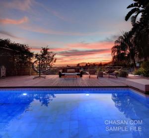 a swimming pool with a sunset in the background at Marbella Boutique Art suites in Marbella
