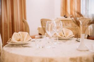 a white table with glasses and napkins on it at Magnolia Hotel Vieste in Vieste