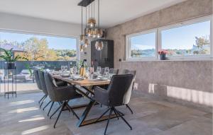 a dining room with a table and chairs at Nice Home In Labin With Sauna in Labin