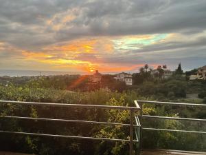 a sunset with the sun setting over a city at Marbella Boutique Art suites in Marbella