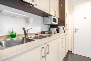 A kitchen or kitchenette at Near Danube & Millenium Tower - Massive Shared 4BR Apt