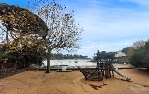a park with a bench and a tree and water at Beautiful Apartment With Wifi in Pornic +11 photos