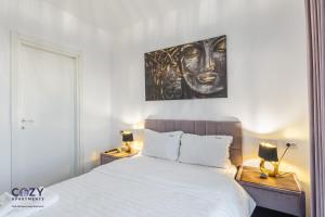a bedroom with a bed and a painting on the wall at Luxury Residences & Suites in Central Brasov at Coresi Mall in Braşov