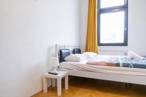 A bed or beds in a room at Near Danube & Millenium Tower - Massive Shared 4BR Apt