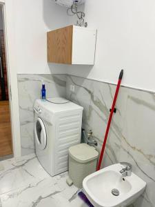 a bathroom with a washing machine and a sink at SAB 2 Cozy Modern Apartment Fier in Fier