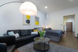 a living room with a couch and a table at Masiarska Apartment 1 Best Adress In City Center Kosice in Košice