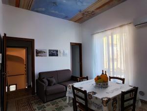 a living room with a table and a couch at Baia delle Sirene by Holiday World in Porticello