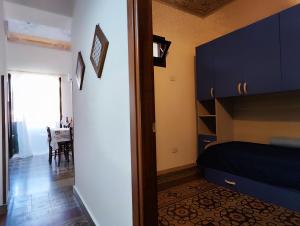 a bedroom with a bed and a dining room with a table at Baia delle Sirene by Holiday World in Porticello