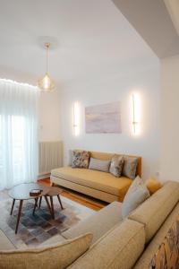 a living room with a couch and a table at CASA BIANCA Kastoria in Kastoria