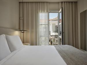 Postel nebo postele na pokoji v ubytování Doryssa Method Hotel