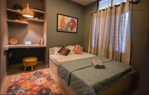 a small bedroom with two beds and a window at Pazuri in Ruiru